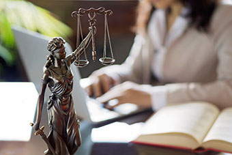 Scales of Justice with Studenht Working in Background