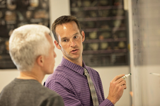 Photo of Teacher and Student at Whiteboard