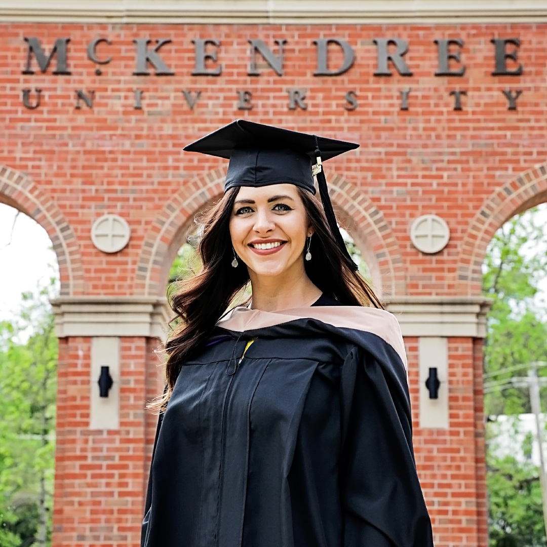 Female MBA Student in Graduation Gown and MBA Hood