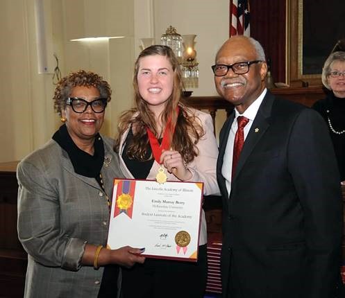 McKendree University senior Emily Berry, a Student Laureate of the Lincoln Academy of Illinois (center), is congratulated by Dr. J.L. Kemp, professor of psychology at McKendree, and Frank Clark, chancellor of The Lincoln Academy of Illinois. (Photo by Dave Blanchette, Studio 131 Photography)