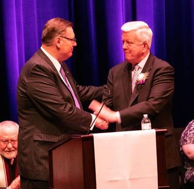 McKendree University President Daniel Dobbins, left, congratulates Dr. James Dennis