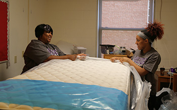 Fenmale Student and Parent Making Residence Hall