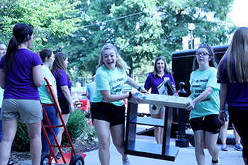 Female Student Carrying Furniture