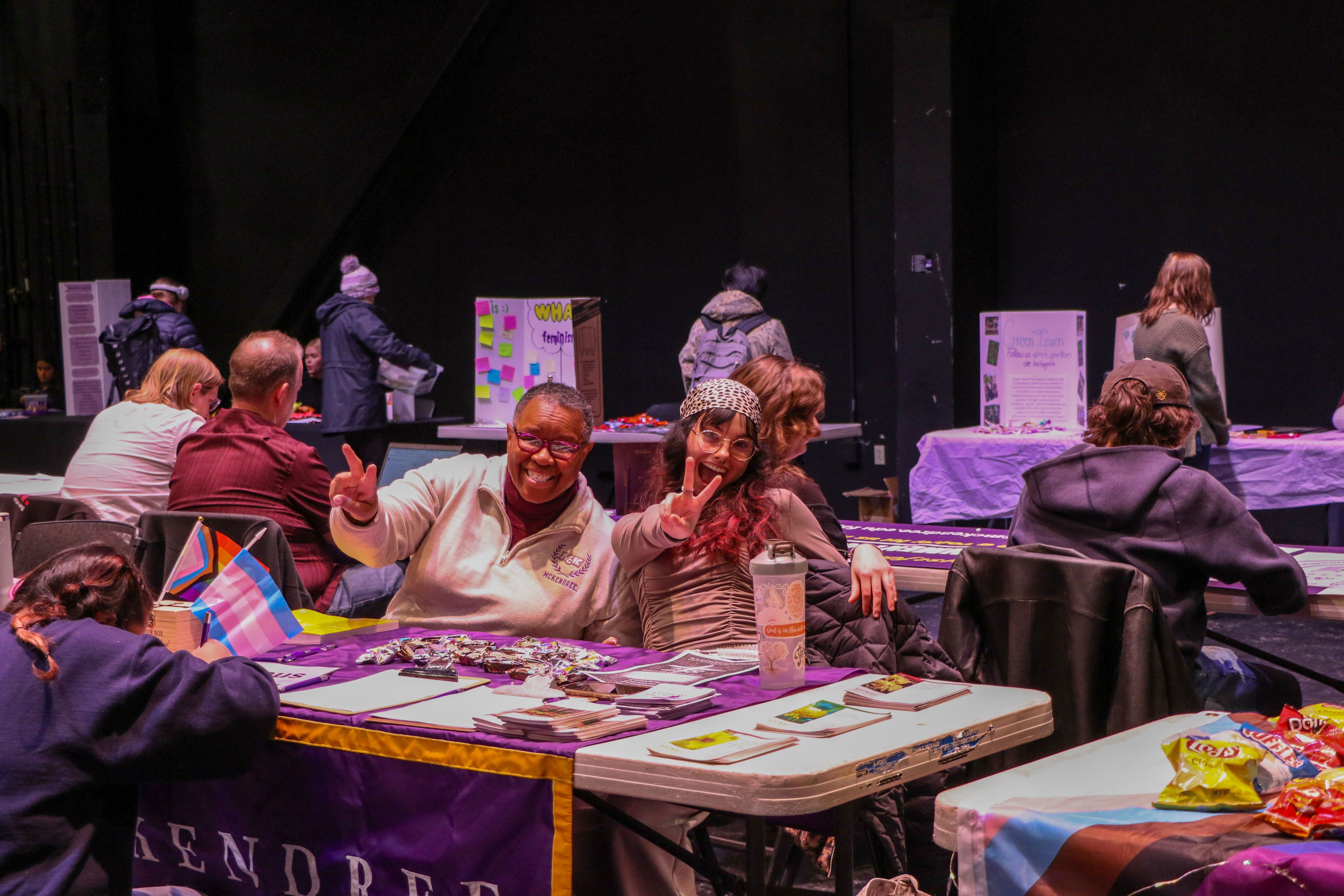 Two smiling people at table