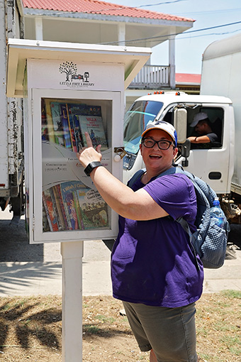 Librarian Pointing to a Free Little Library